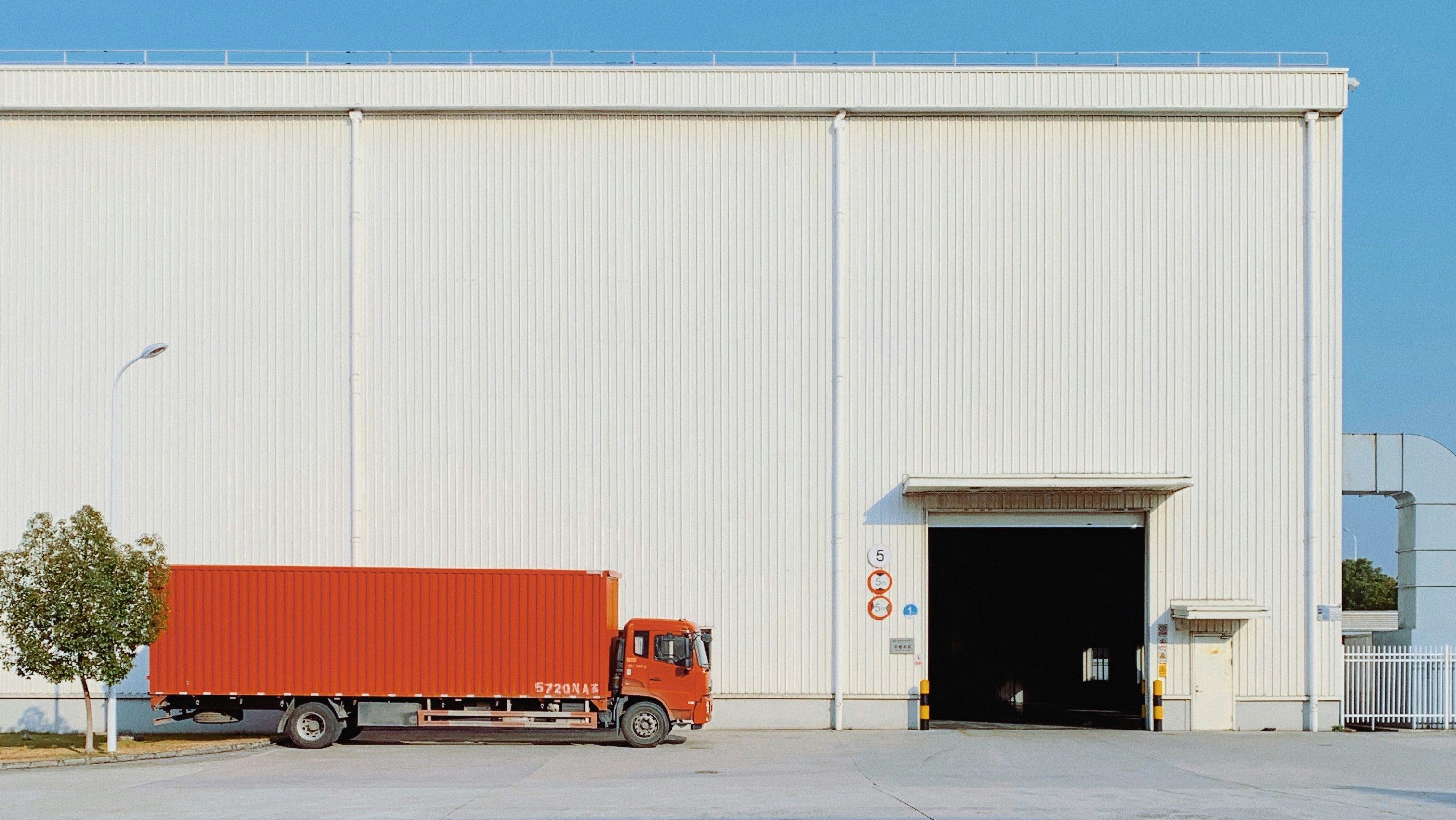 red freight truck beside building