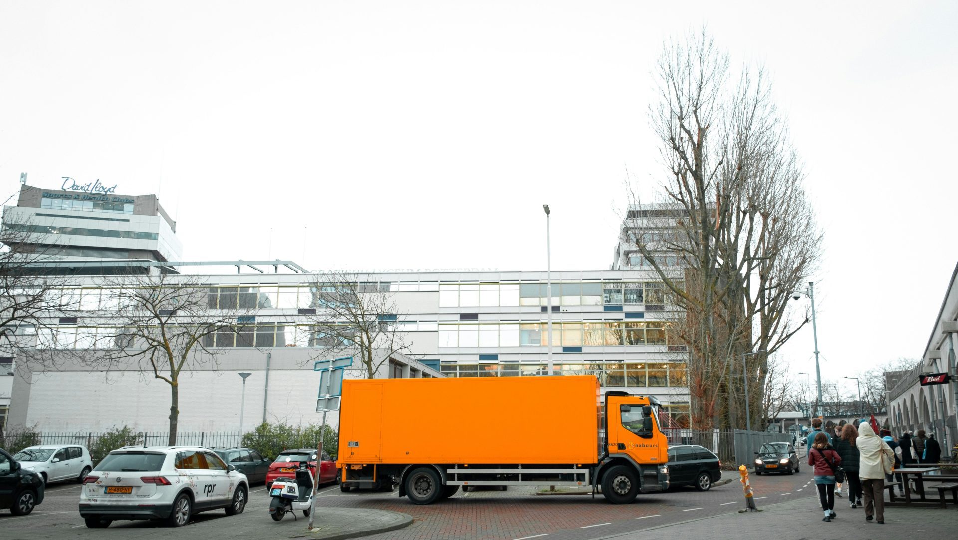 a large orange truck parked in a parking lot